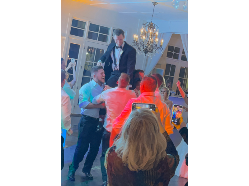 Groom up in the air on a chair wedding Little River Farms Alpharetta GA DJ